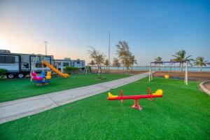 a playground with a toy plane on the grass at منتجع شاطئ الورد in Yanbu