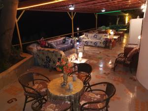 a living room with couches and a table and chairs at evli in Rethymno