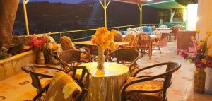 a table with a vase of flowers on a balcony at evli in Rethymno