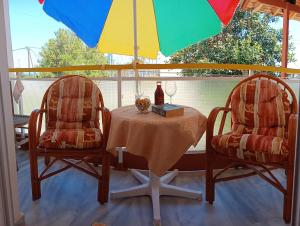 a table and chairs under an umbrella on a porch at evli in Rethymno