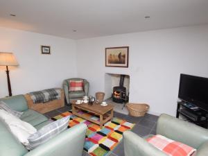 a living room with a couch and a fireplace at 3 Bed in North Uist 77239 in Sollas