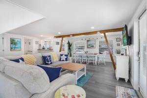 布雷登頓海灘的住宿－Seagrape Cottage，客厅配有沙发和桌子