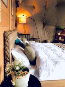 a bed in a tent with flowers on it at Bolnisio Resort in Bolnisi