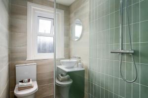 a bathroom with a toilet and a sink and a shower at Kist Accommodates - Hughenden Haven in Harrogate