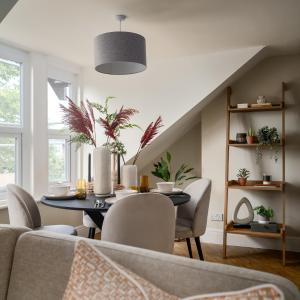 a dining room with a table and chairs at Kist Accommodates - Hughenden Haven in Harrogate