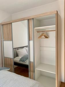 um armário espelhado com uma cama num quarto em Apartment Kvadar em Banja Luka