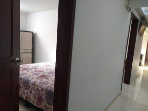 a bedroom with a bed and a door to a room at My second house in Manizales