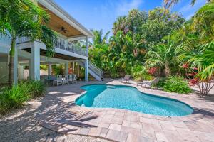 a swimming pool in front of a house at Spring Haven in Anna Maria