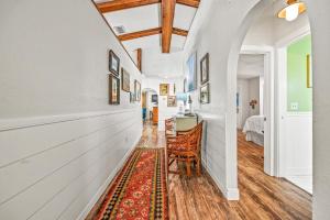 a hallway with a chair and a table in a room at Buttonwood Cottage in Anna Maria