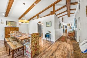 a dining room and living room with a table and chairs at Buttonwood Cottage in Anna Maria