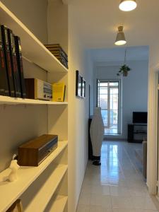 a room with a book shelf with books at Ilaria’s Apartment in Rome