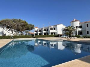 a large swimming pool in front of a building at Sa Posta in Cala en Forcat