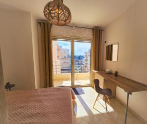a bedroom with a desk and a large window at Dream in Durrës