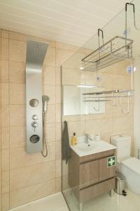 a bathroom with a sink and a shower at Casa Barros Serra in Calheta