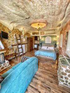 a bedroom with two beds and a stone wall at Anilia Guesthouse in Synikia Mesi Trikalon