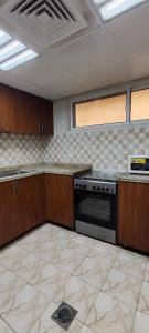 an empty kitchen with a stove and some cabinets at Al Khaleez Accommodation in Dubai