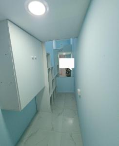 a room with a hallway with blue walls and a ceiling at Al Khaleez Accommodation in Dubai