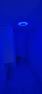 a dark room with a blue ceiling with a light at Al Khaleez Accommodation in Dubai