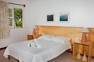 Hotel Karapitangui tesisinde bir odada yatak veya yataklar