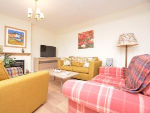 a living room with two couches and a tv at 2 Bed in Carnoustie 58026 in Monikie