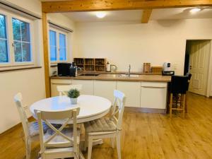 a kitchen and dining room with a table and chairs at Ferienwohnung in Aistersheim 