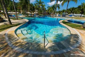 a large swimming pool with people in the water at Flat em Resort com vista para o Mar! in Angra dos Reis