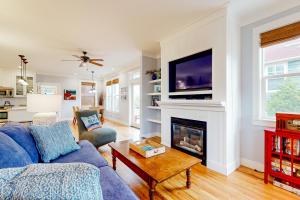 a living room with a blue couch and a fireplace at Jewel Box at the Beach in Lincoln City