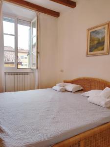 a bedroom with a bed with two pillows and a window at 1Dest - City Center Charme in Riva del Garda