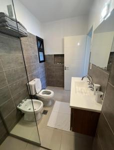 a bathroom with a toilet and a sink at Casaabril in Villa Carlos Paz