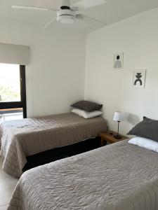 a bedroom with two beds and a window at Casaabril in Villa Carlos Paz