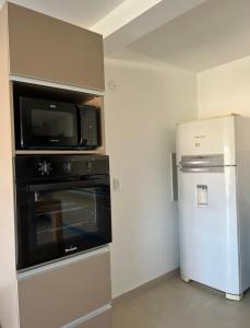 a kitchen with a microwave oven and a refrigerator at Casaabril in Villa Carlos Paz