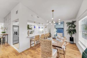 a dining room and kitchen with a table and chairs at Surf Side in Anna Maria