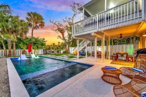 an image of a house with a swimming pool at Surf Side in Anna Maria
