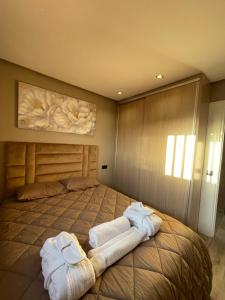 - une chambre avec un grand lit et des serviettes dans l'établissement Super appartement avenue hassan 2, à Agadir