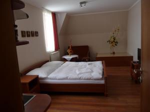 a small bedroom with a bed in a room at Guest House Penzión Fortuna in Tvrdošín