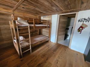 a room with two bunk beds in a cabin at Apartments Bedanc in Kranjska Gora
