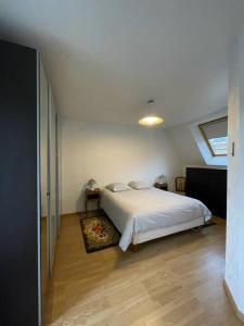 a bedroom with a white bed and a window at Charming City Home Near Downtown with Garage in Amiens