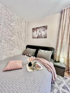 a bedroom with a bed with a tray of food on it at New Stylish Apartment City Center in Narva