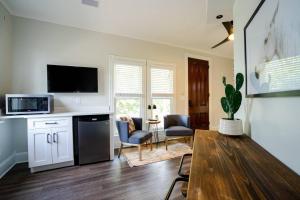 a kitchen with a table and a living room at The Charming Cowboy in Denver