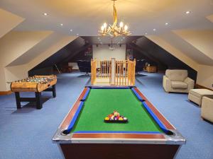a living room with a pool table and a room with a room at Gleann Fia House in Arrochar