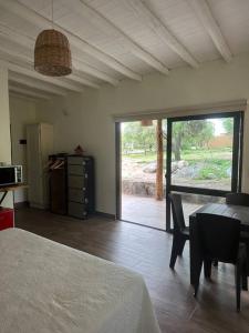a bedroom with a bed and a sliding glass door at Casa Algarrobos in San Javier