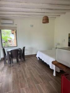 a room with a bed and a table and chairs at Casa Algarrobos in San Javier