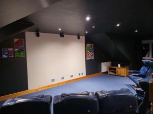 a large white screen in a room with chairs at Gleann Fia House in Arrochar
