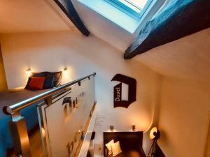 a room with a loft with a bed and a staircase at La Vieille Forge in Houffalize