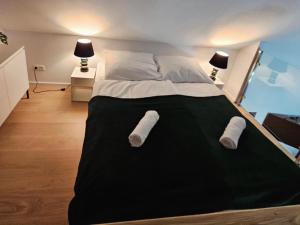 a bedroom with a large bed with two towels on it at Elizjum pod Śnieżką in Bukowiec