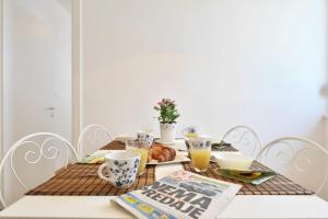 a dining room table with breakfast foods and a magazine at Apartment Karlo in Split