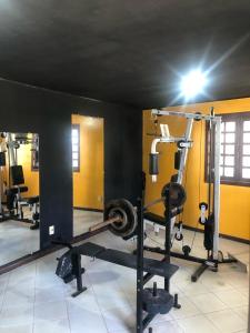 a gym with several tread machines in a room at Apartamento inteiro n.24 in Porto Seguro
