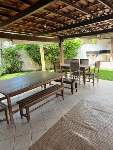 a wooden table and chairs on a patio at Apartamento inteiro n.24 in Porto Seguro