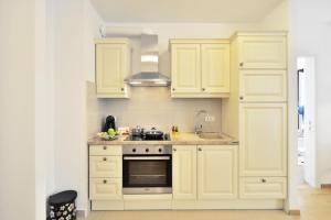a kitchen with white cabinets and a stove at Apartment Karlo in Split