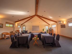 a conference room with tables and chairs and a chalkboard at Carrington Estate in Tokerau Beach